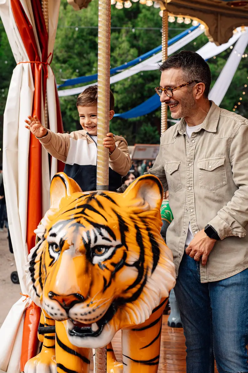 Bambino sulla tigre della giostra con il papà — Parco d’Autunno al Raffo Parco Gondar di Gallipoli